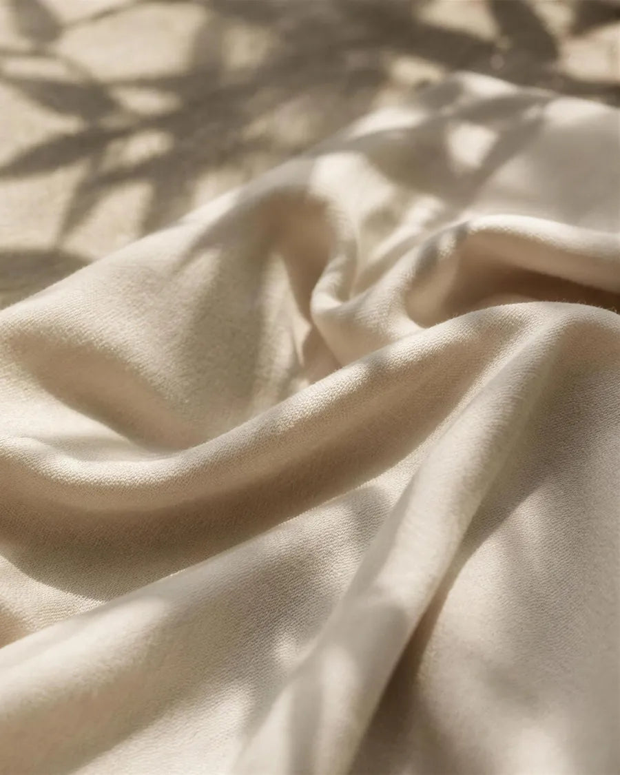 Cream bamboo jersey with shadows of bamboo leaves falling across it