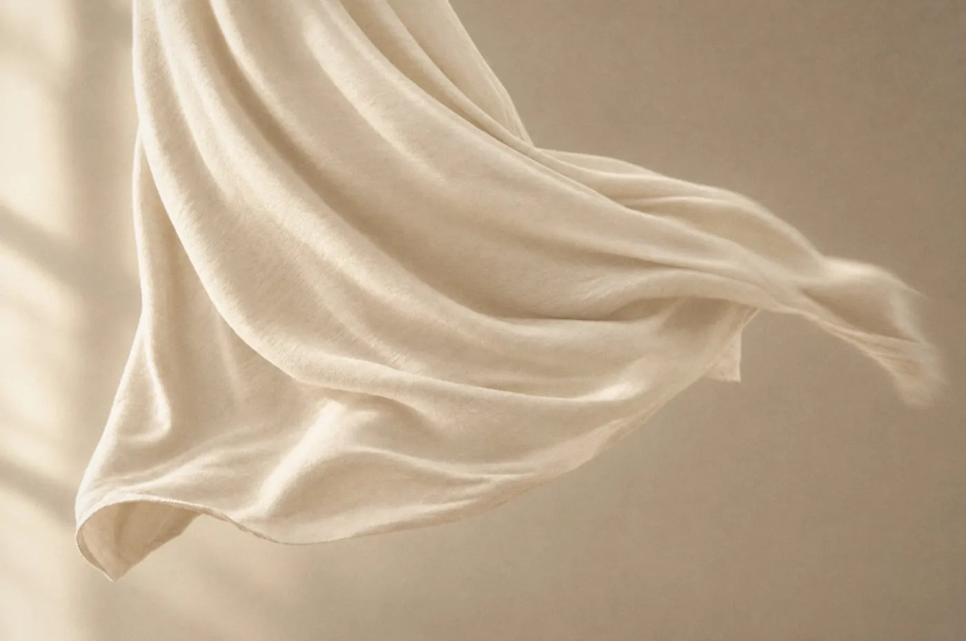 Soft cream bamboo jersey floating in warm window light